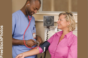A nurse checking a patient's blood pressure