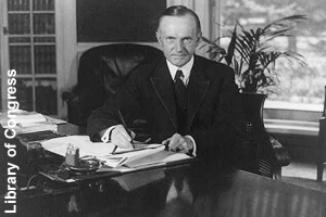 President Coolidge sitting in the Oval Office <br>of the White House