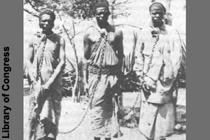 A picture showing three male slaves